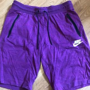 Nike purple shorts with zipper side pockets. Snap back pocket.